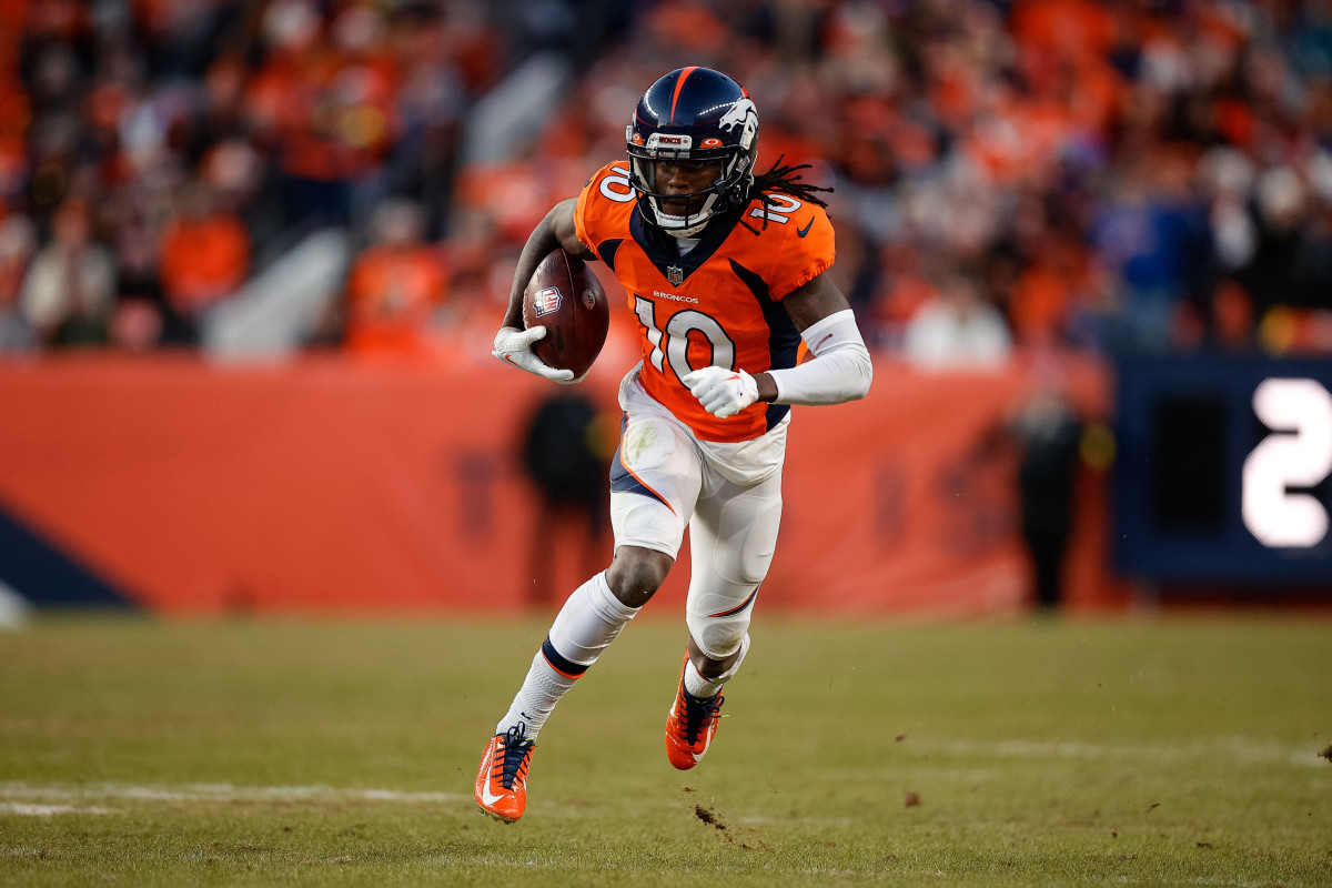 Denver Broncos wide receiver Jerry Jeudy runs with the football under one arm